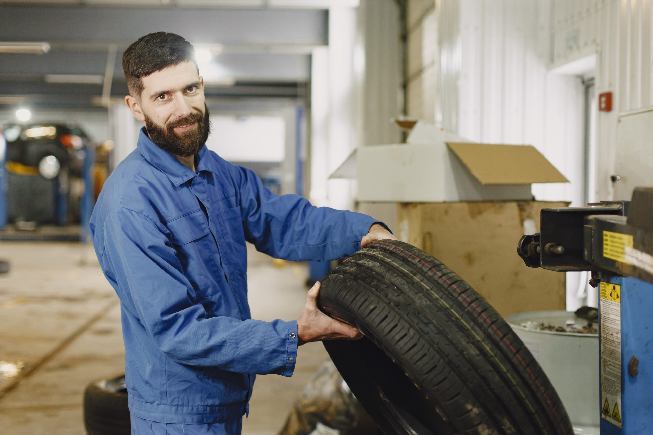 Orange car. Work in garage. Work with wheel.